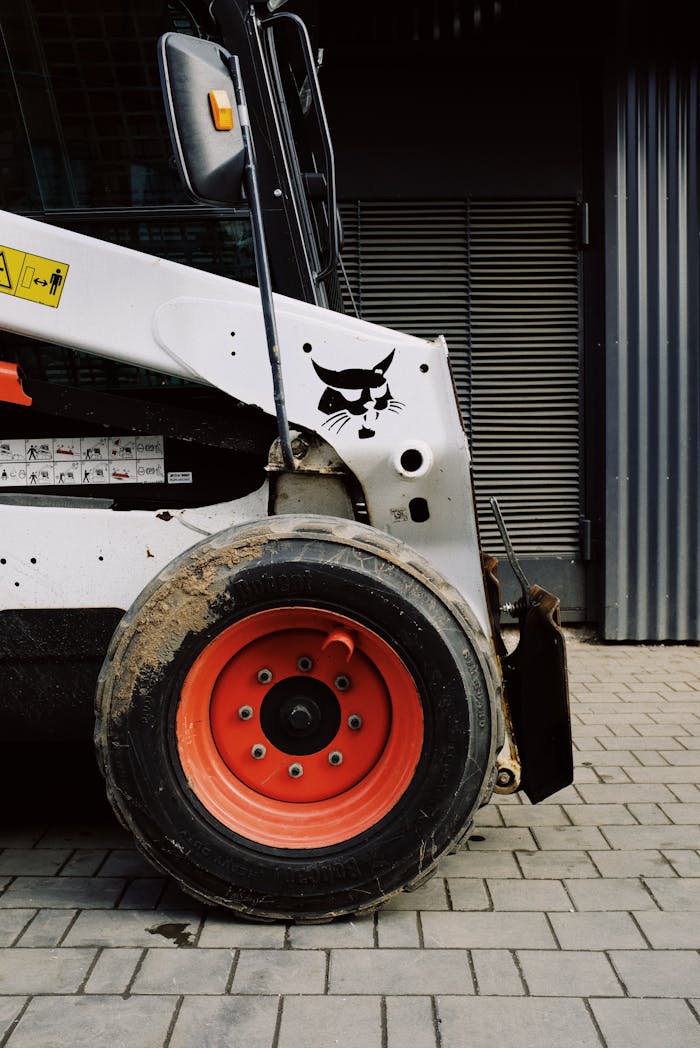 Mastering the First Impression: Your intriguing post title goes here Side view of mini loader in garage waiting for installation arm after repairing