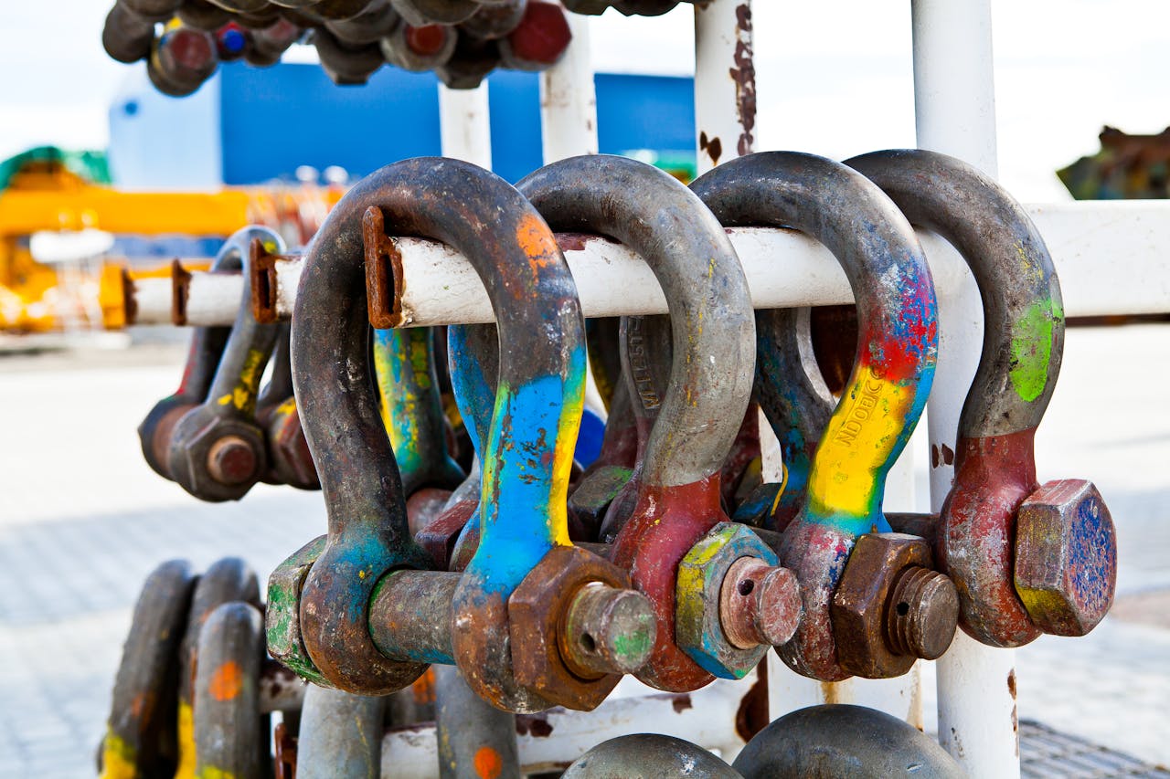 The Art of Drawing Readers In: Your attractive post title goes here Close-up of colorful rusted shackles on a rack, showcasing industrial wear and vibrant paint.